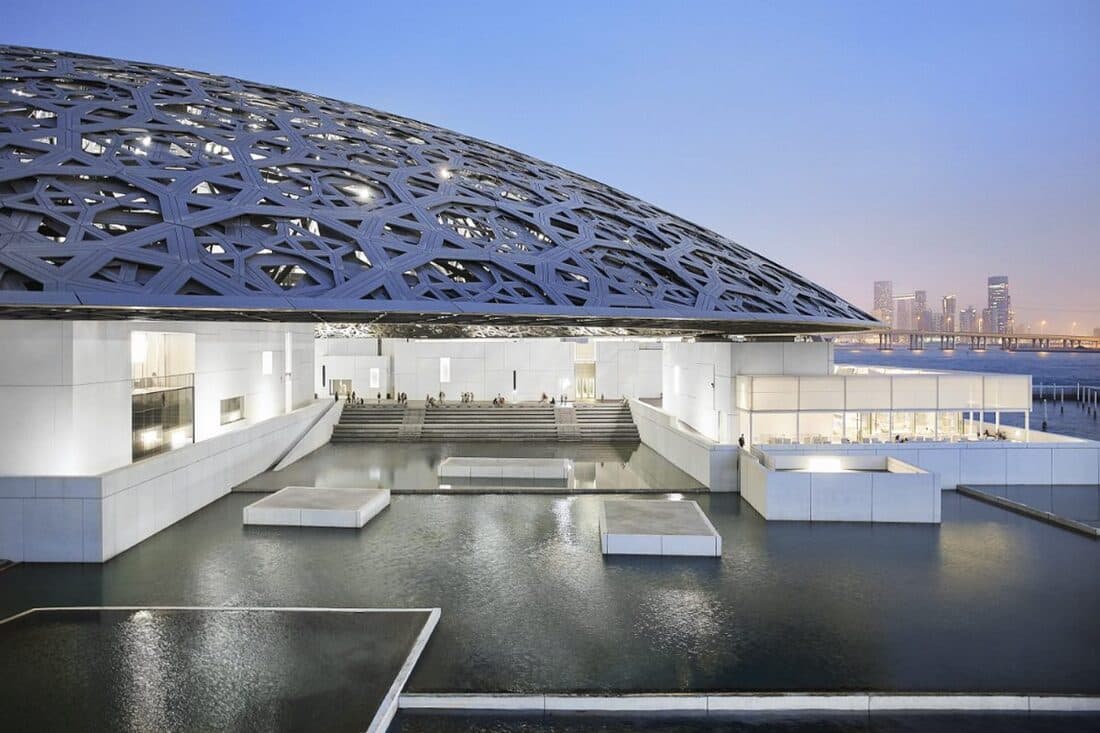 Exterior view of Louvre Abu Dhabi with its iconic dome and waterfront setting.