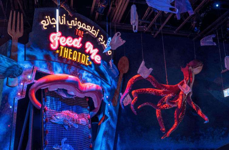 A stage at Expo City DubaiTerra featuring a large octopus suspended from the ceiling, creating a whimsical atmosphere.