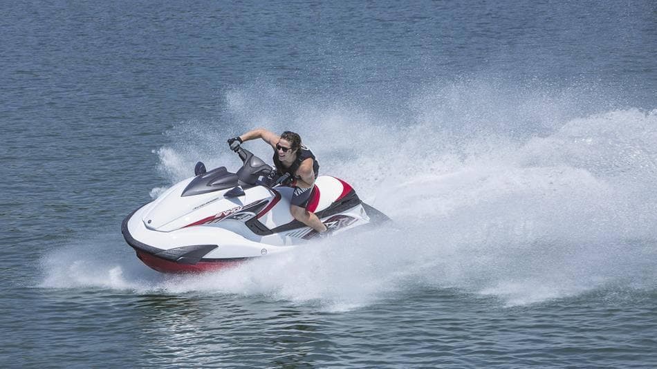 A man riding a jet ski on a lake during a Jet Ski tour in Dubai, showcasing excitement and adventure.
