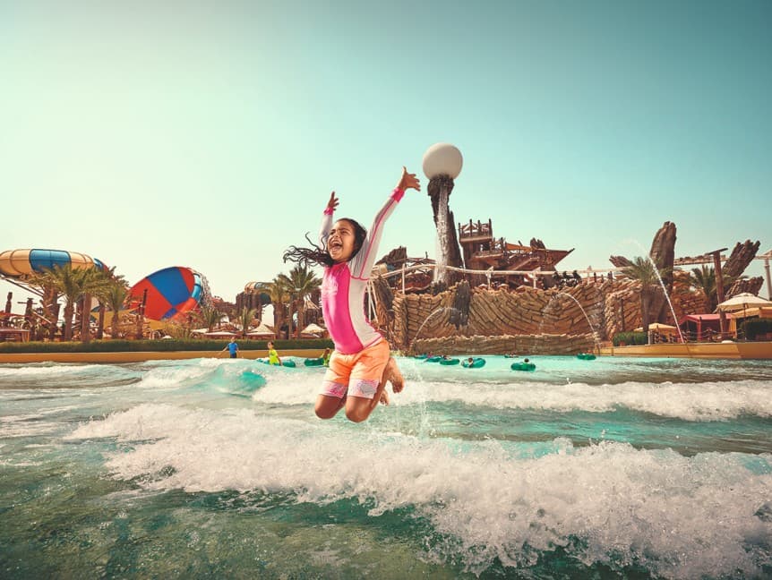Kids enjoying waves and splashing water in the Kids Wave Pool at Yas Waterworld Abu Dhabi