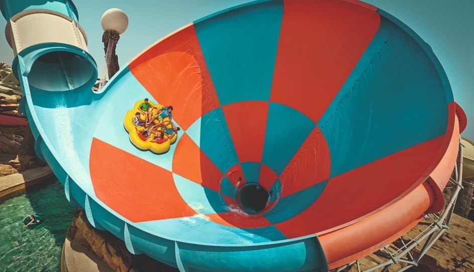Guests riding the Dawwama tornado-style water slide attraction at Yas Waterworld Abu Dhabi