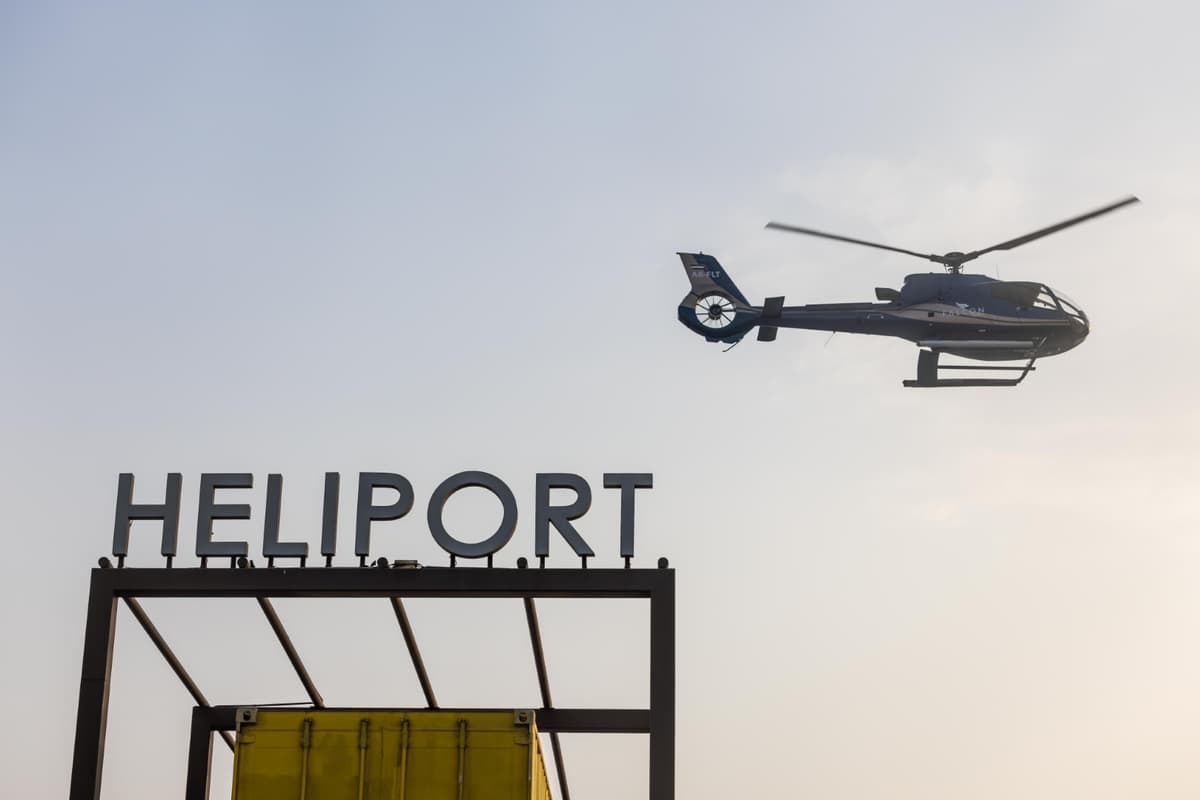 Heliport sign against the sky, indicating takeoff for a helicopter tour in Abu Dhabi.