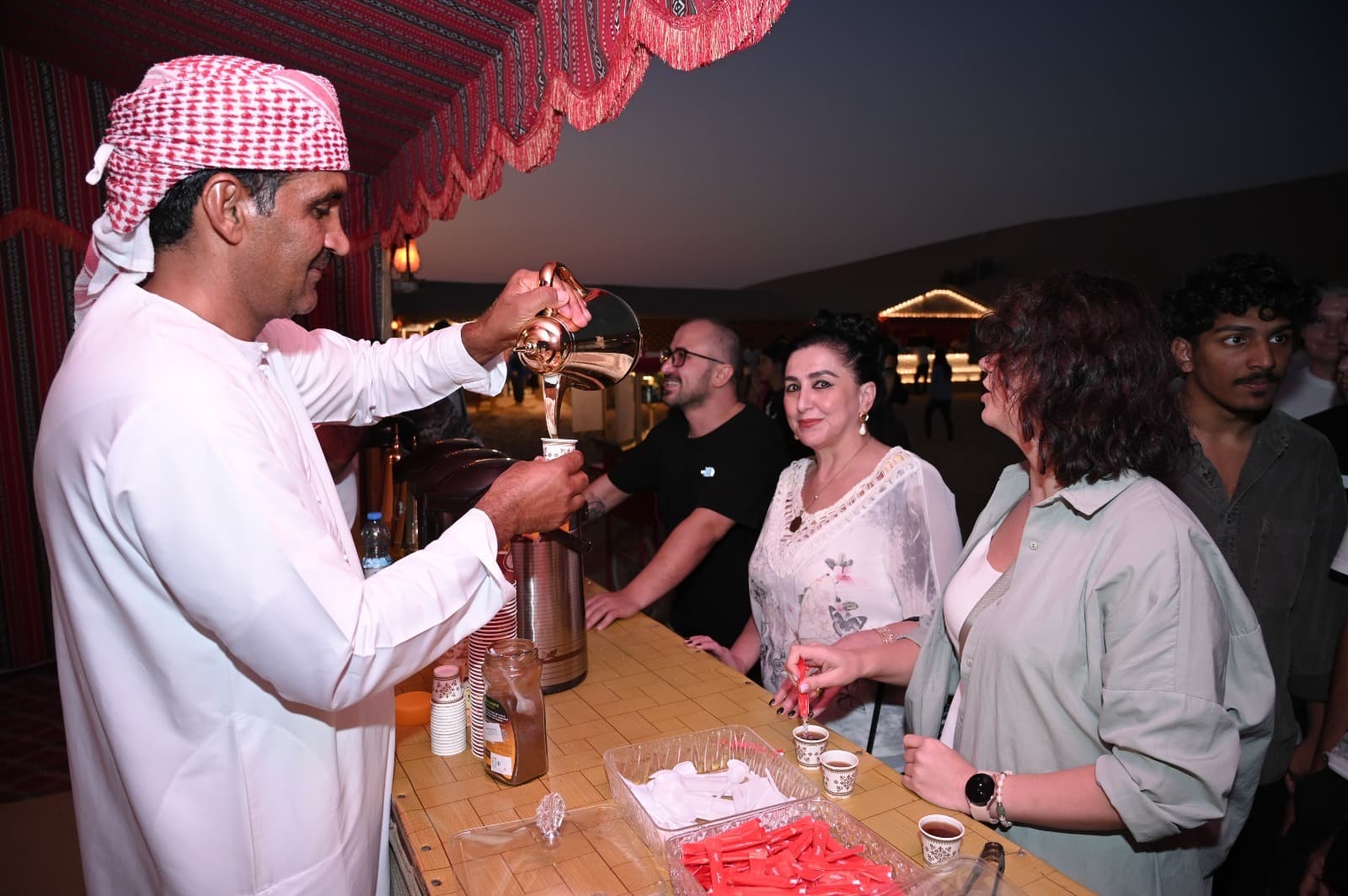 Guests enjoying traditional tea at the desert camp during the Abu Dhabi Desert Safari experience