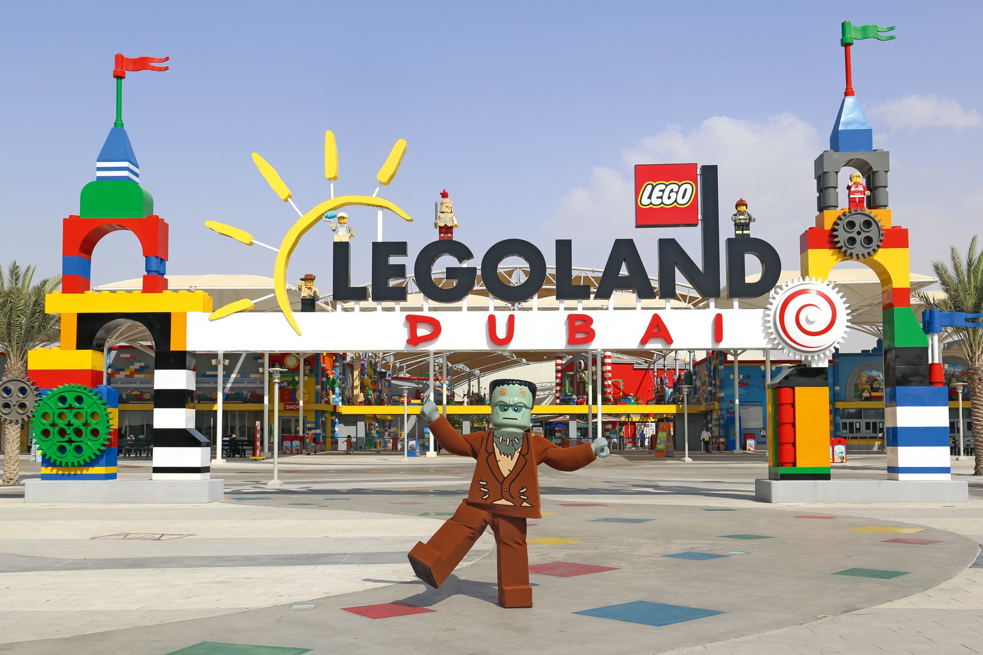 Entrance of LEGOLAND Dubai and sculptures with a LEGO Frankenstein figure in front.