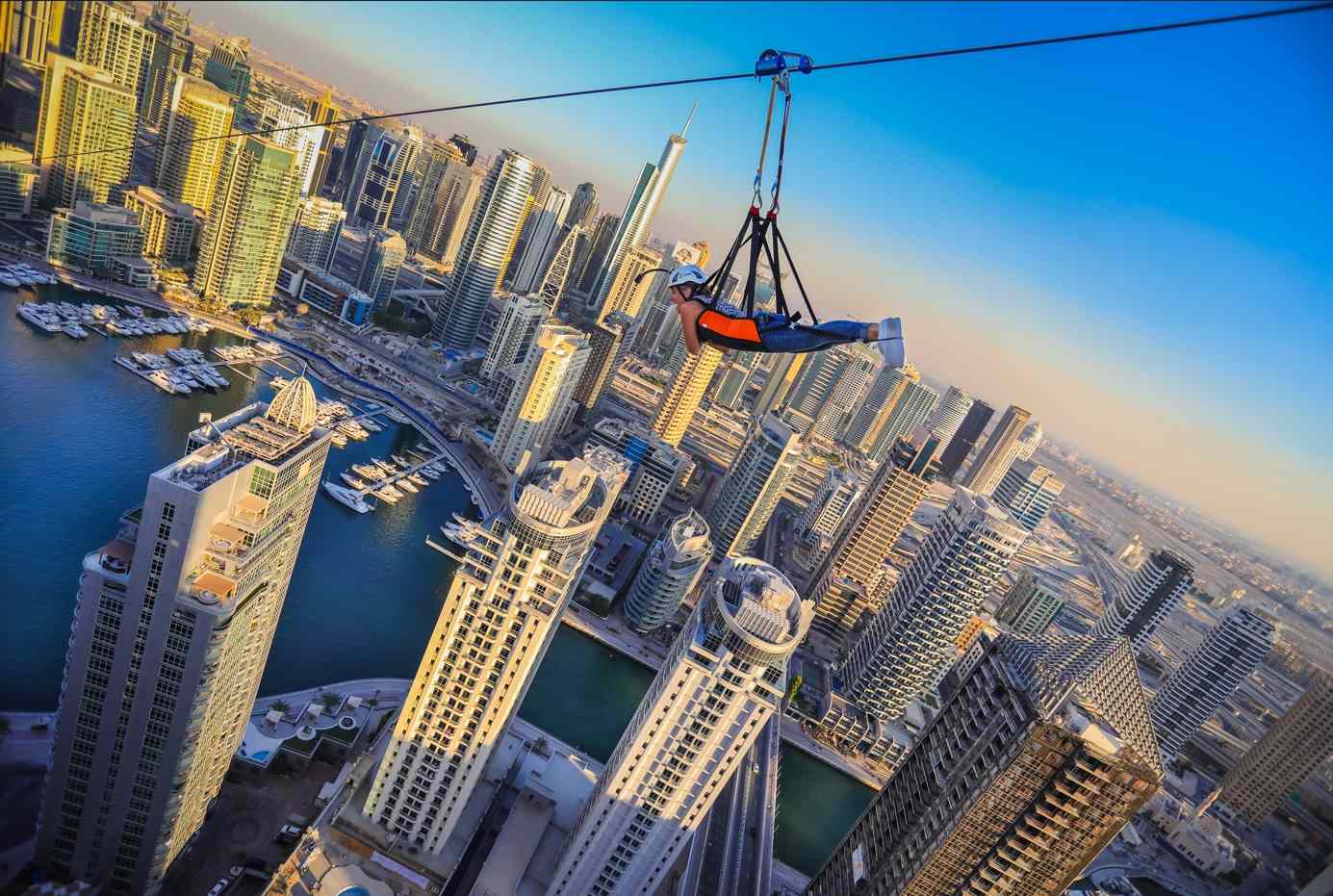 Thrilling XLine Dubai Marina zipline ride with riders soaring above the city skyline