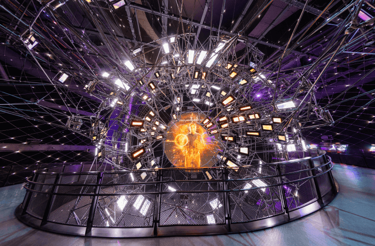 A large circular structure adorned with lights and wires, located at Vision Expo City in Dubai.