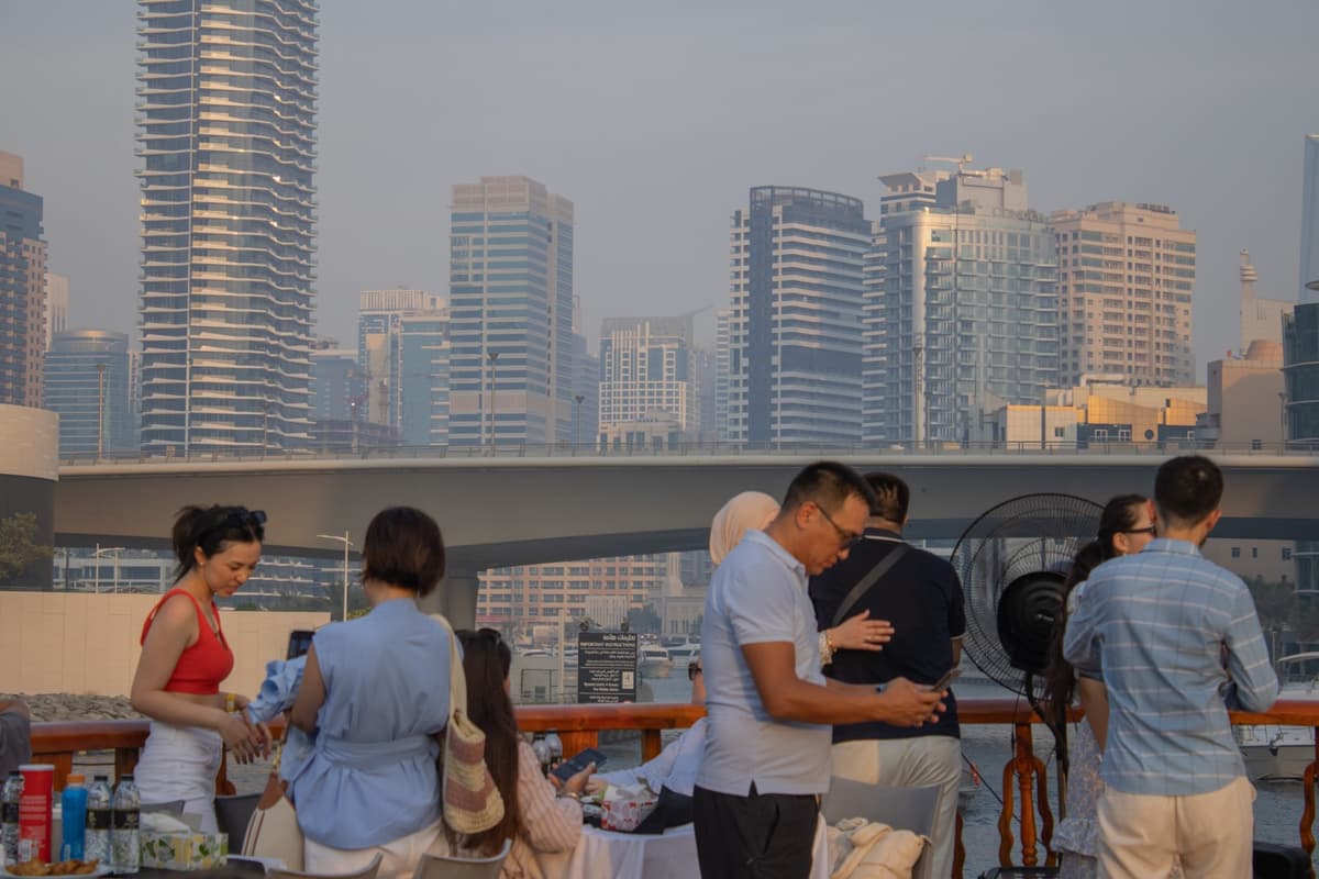Upper deck guests enjoying sunset scenery on a Marina dhow cruise