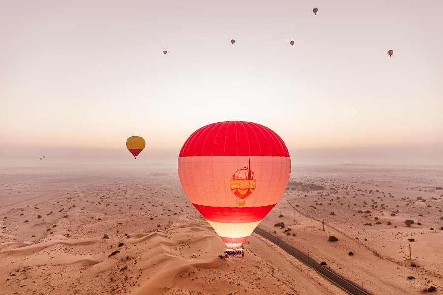Hot air balloon floating over the Dubai desert during an exciting early morning adventure.