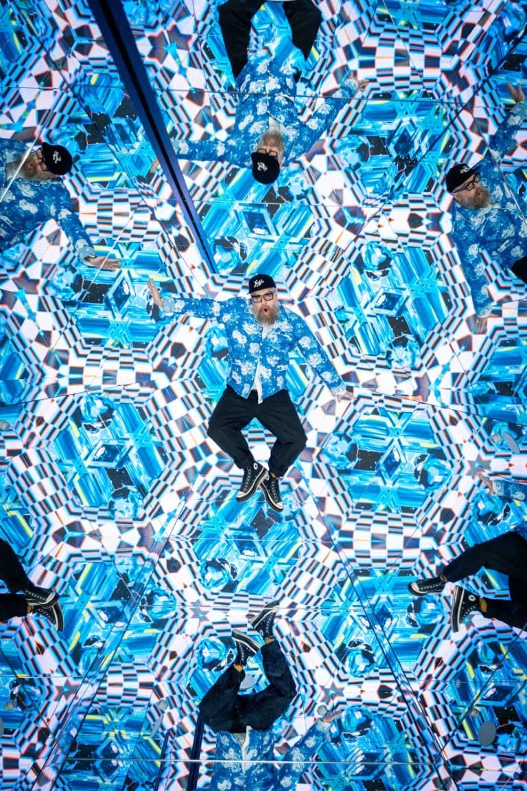 mirror room of House of Hype, Dubai, with a man visible in the reflection.