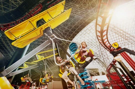 Kids enjoying a fun hanging ride experience at Ferrari World Abu Dhabi on Yas Island
