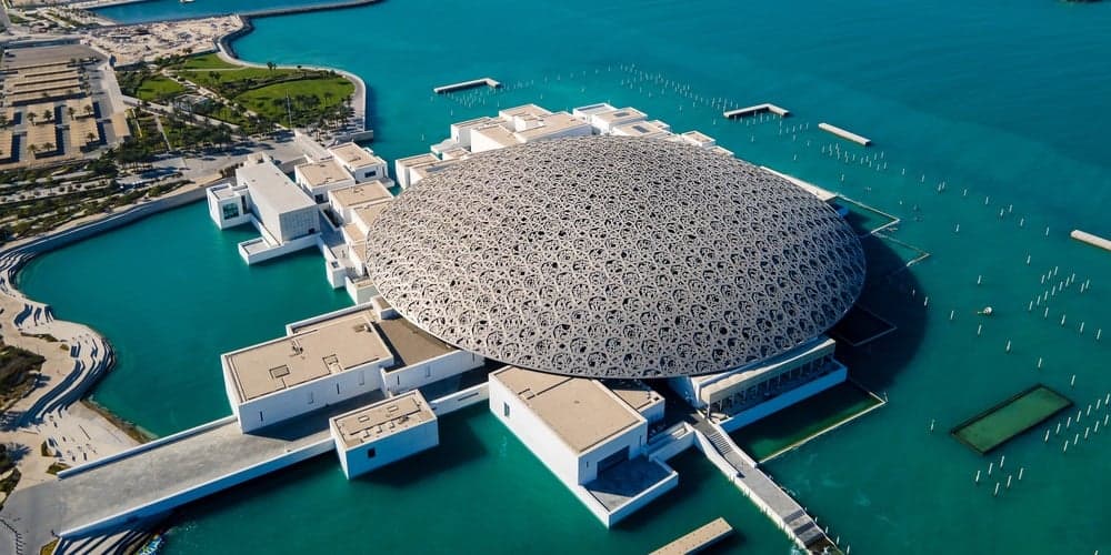 Wide view of the Louvre Abu Dhabi museum complex with its iconic dome and waterfront architecture