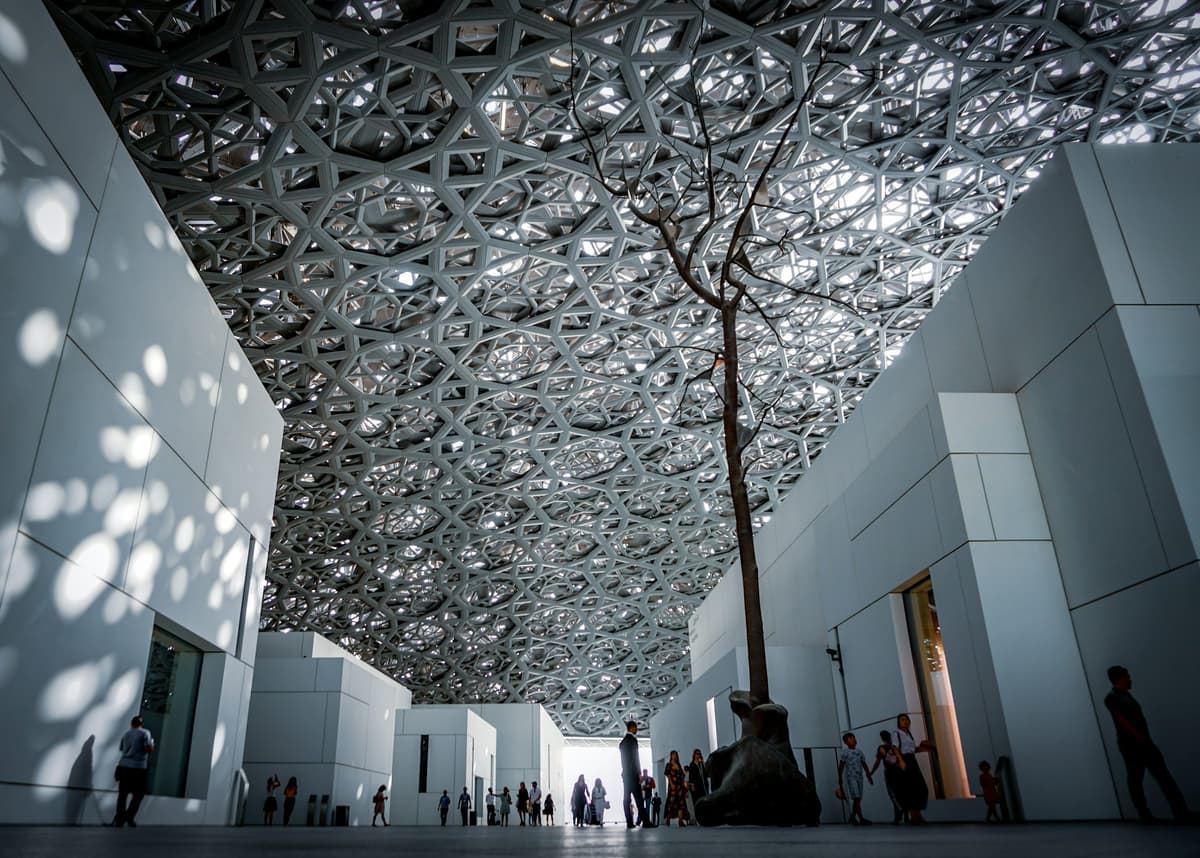 Interior design of Louvre Abu Dhabi showcasing modern galleries and elegant architectural details.