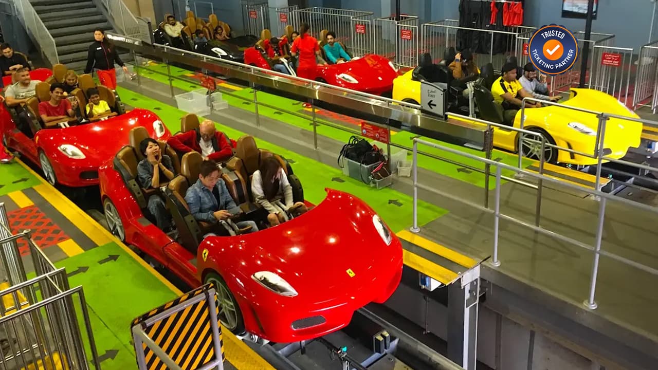 Visitors enjoying thrilling rides inside Ferrari World Abu Dhabi, the indoor Ferrari-themed amusement park on Yas Island.