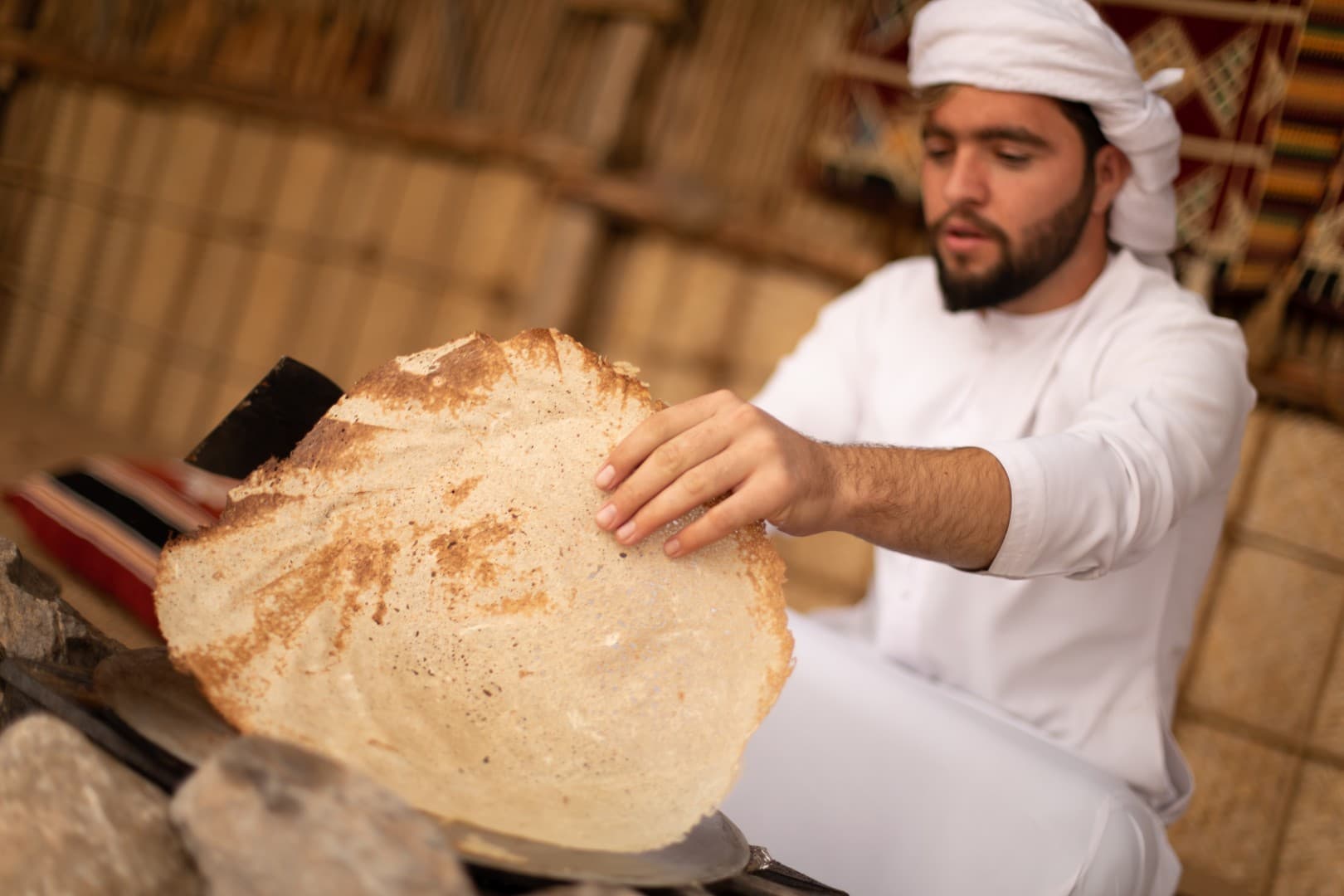 Traditional bread station at the Bedouin camp during the Heritage Desert Safari experience in Dubai.