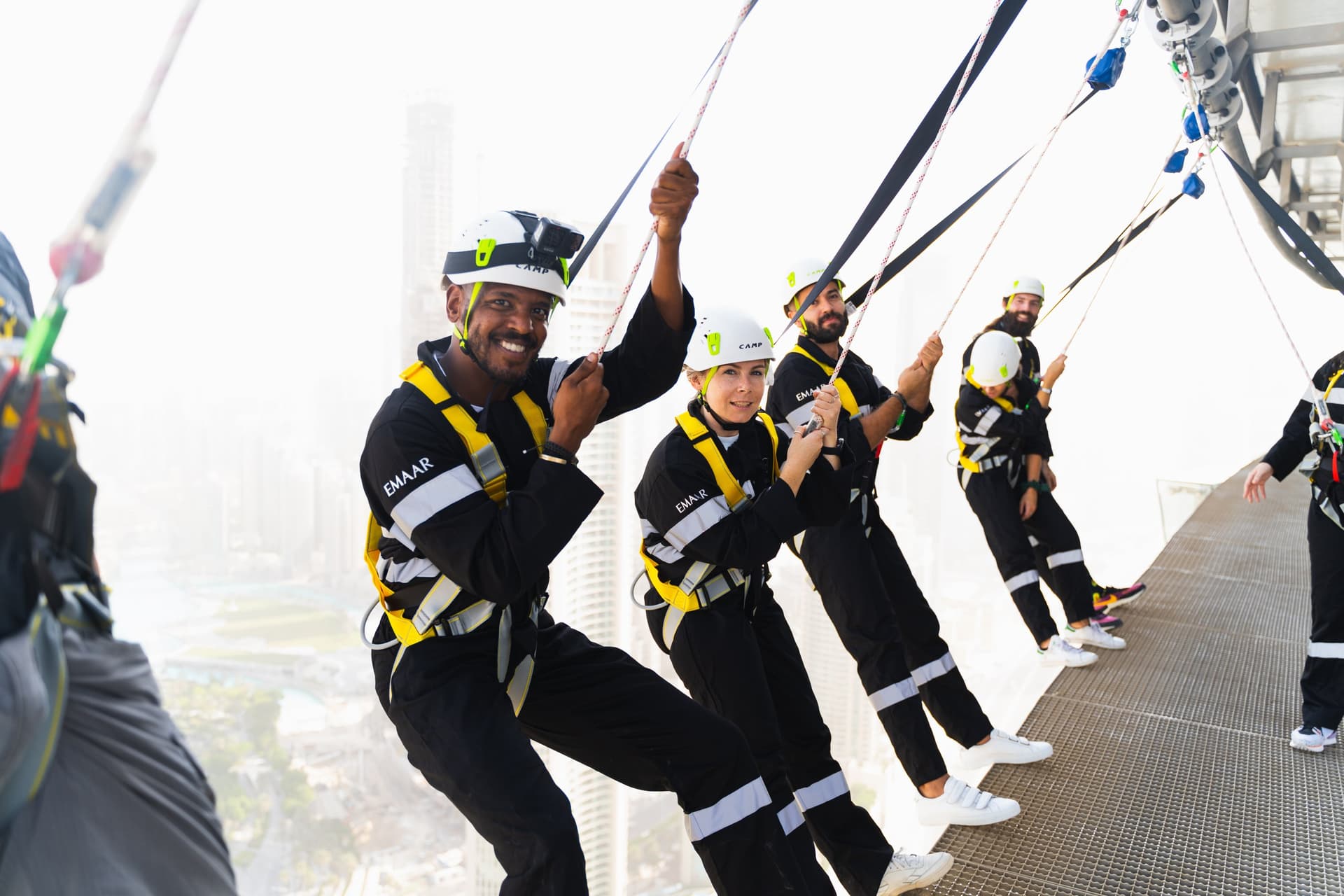 Visitor experiencing the Edge Sky Hang activity at Sky Views Dubai while suspended high above the city skyline