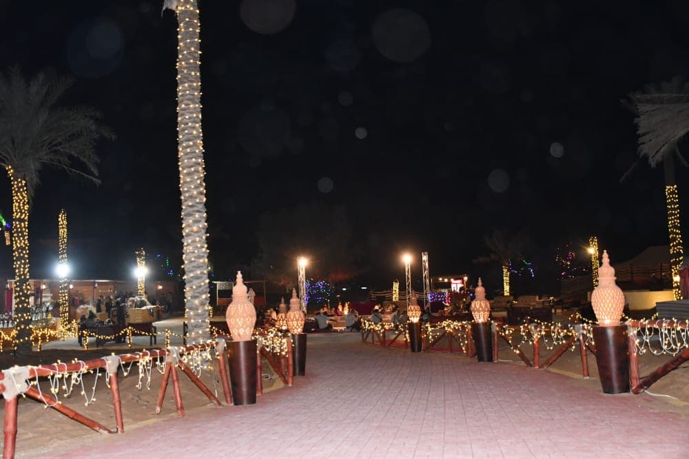 Desert camp illuminated under the night sky during the Ras Al Khaimah desert safari experience.