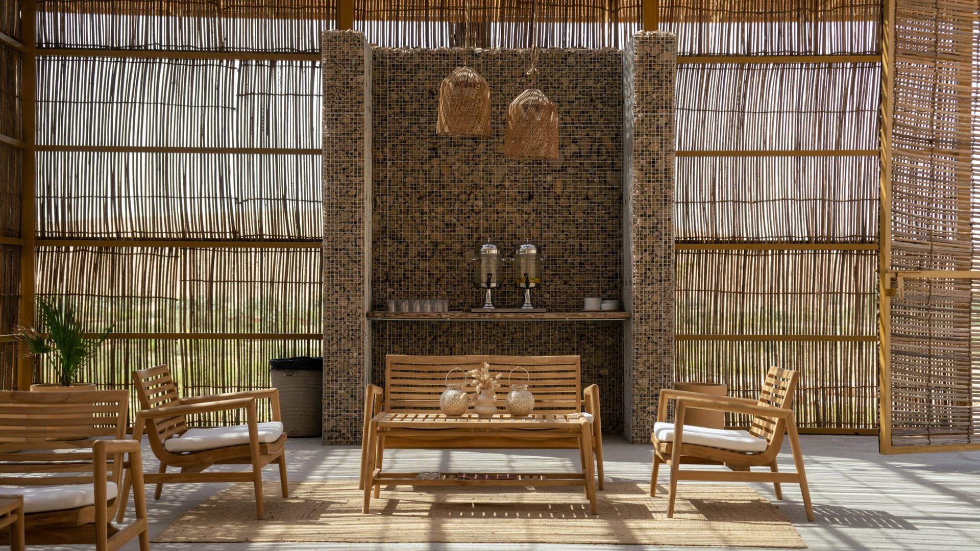 A room at Mleiha Buggy Camp featuring wooden furniture and a large window allowing natural light.