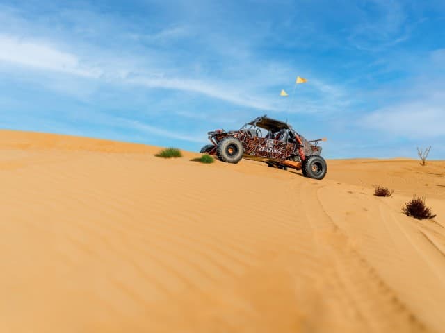 A desert buggy navigating through sand dunes during a Mleiha Buggy Adventure.