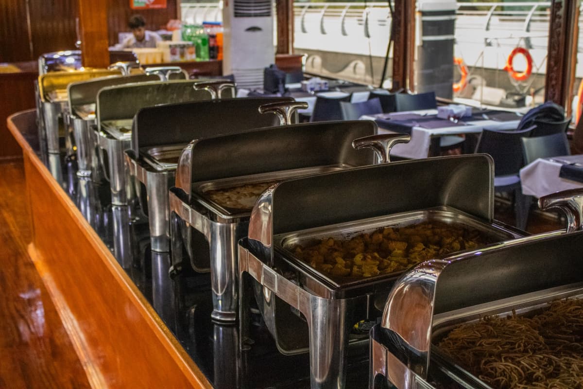 Dining buffet setup on a Marina dhow cruise during sunset