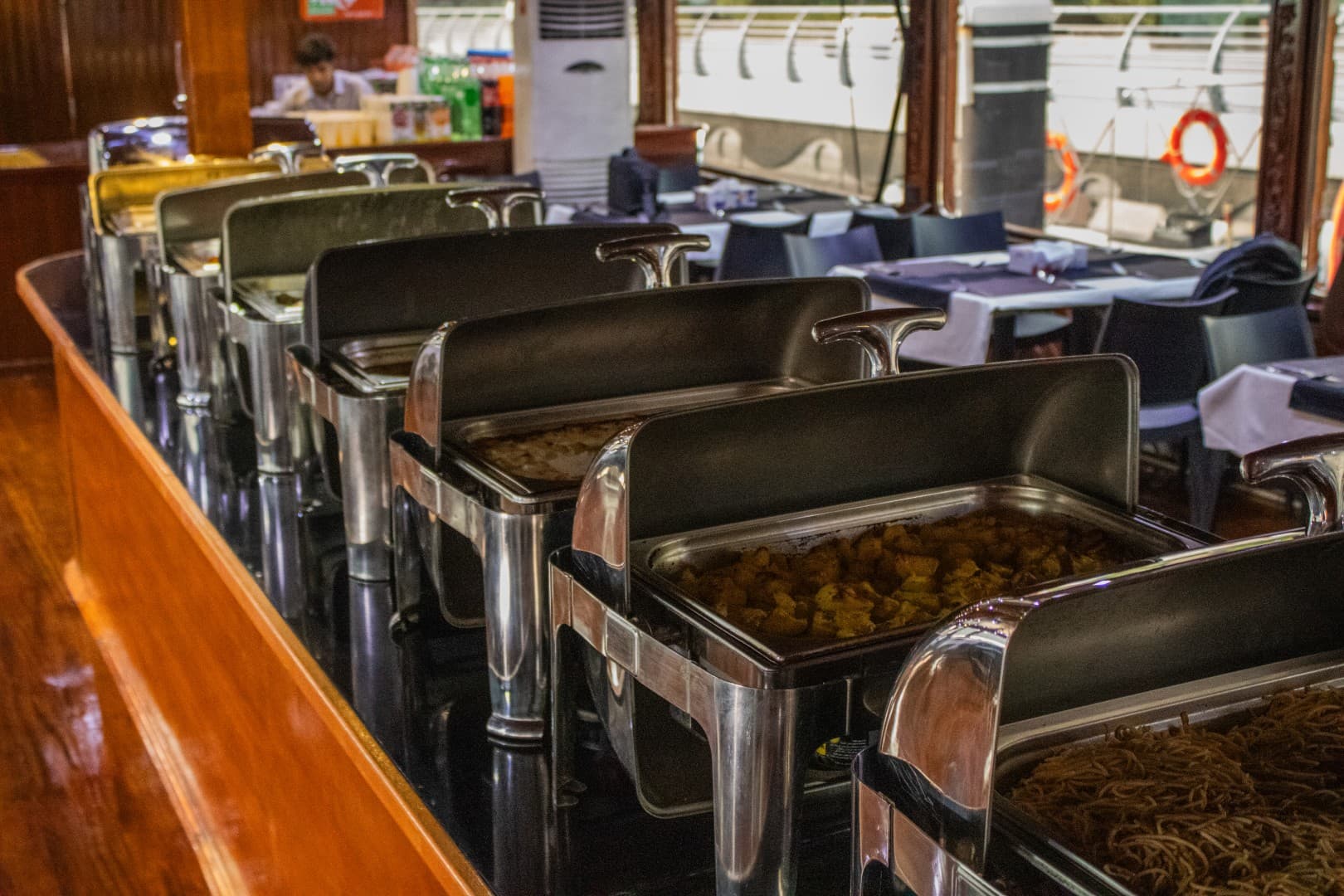 Dining buffet setup on a Marina dhow cruise during sunset