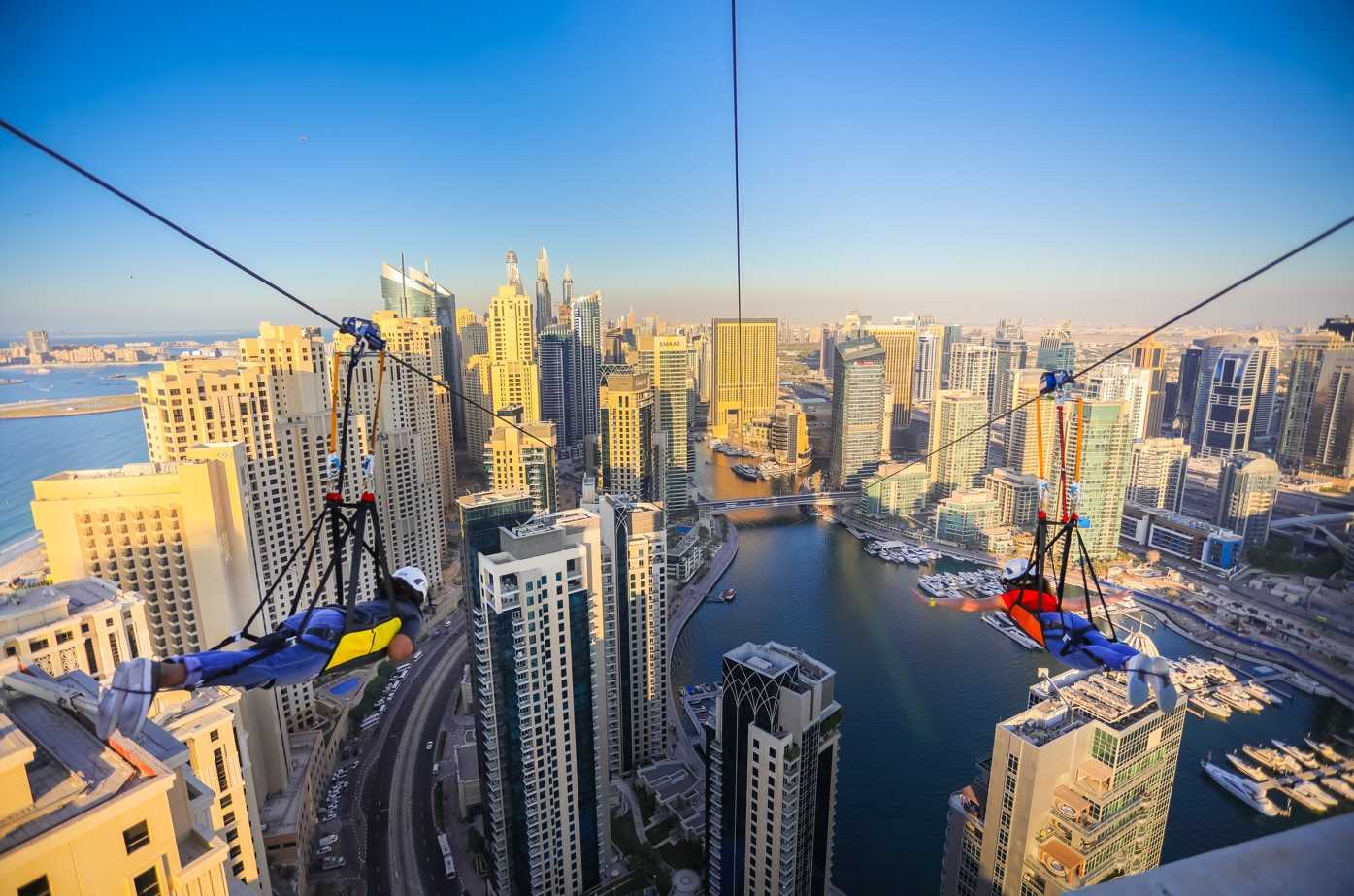 POV view of the XLine Dubai Marina zipline ride flying above Dubai Marina skyline.