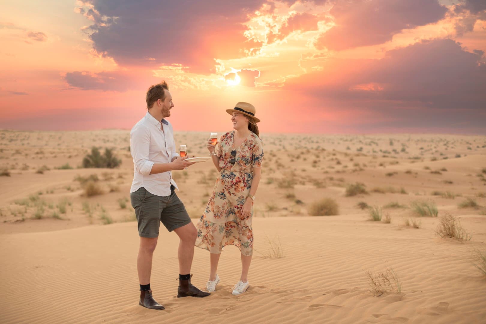 Couple enjoying a romantic sunset moment during the Platinum Desert Safari in Dubai.