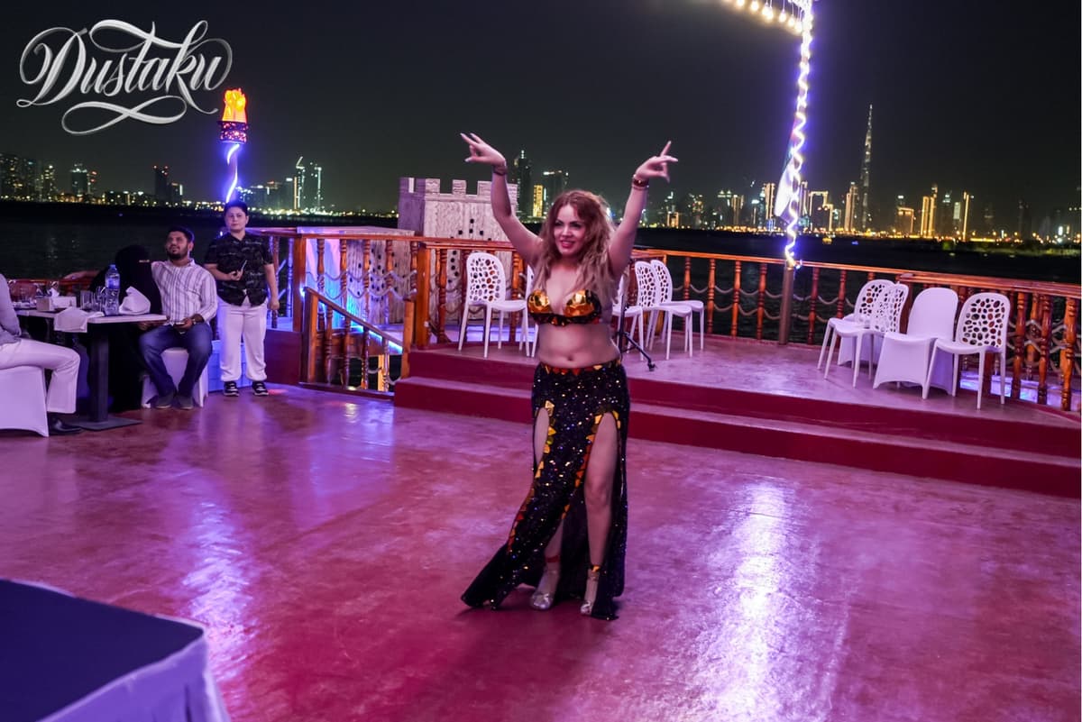 A woman in a belly dance costume performs on a boat during the Dustaku Dinner Dhow Cruise.