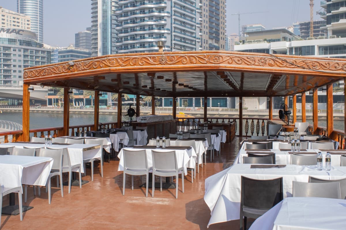 Outdoor seating on upper deck during Dubai Marina sunset dhow cruise