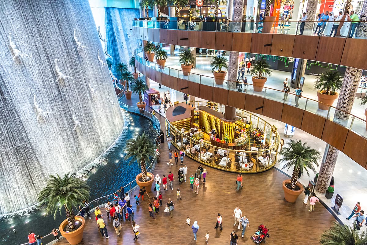 Russian-speaking tourists inside The View at The Palm observation deck during a Dubai city tour.