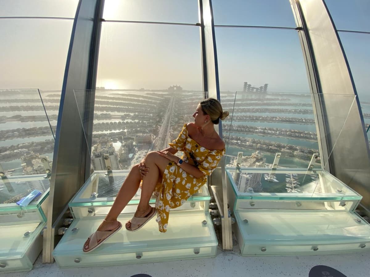 Guests enjoying a sunset photo shoot at The View at The Palm Jumeirah with the island and sea in the background.