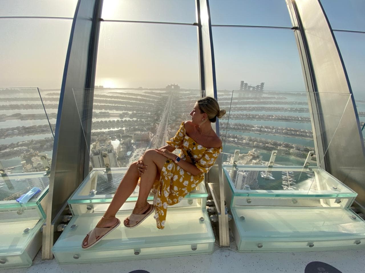 Guests enjoying a sunset photo shoot at The View at The Palm Jumeirah with the island and sea in the background.