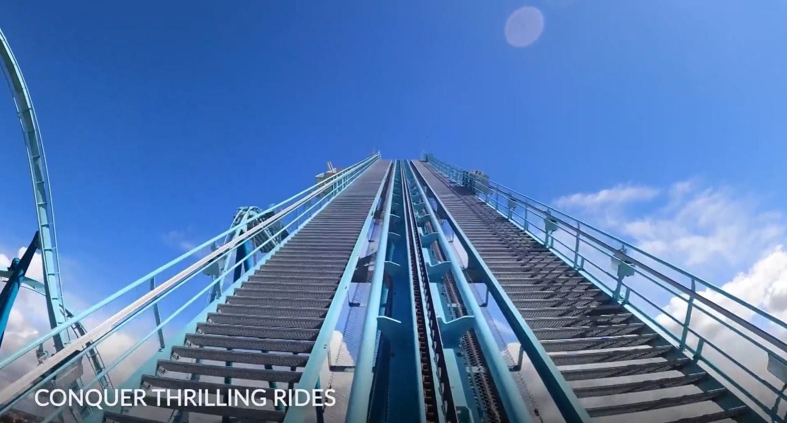 A roller coaster against a clear blue sky at SeaWorld Abu Dhabi, showcasing thrilling rides and vibrant amusement.
