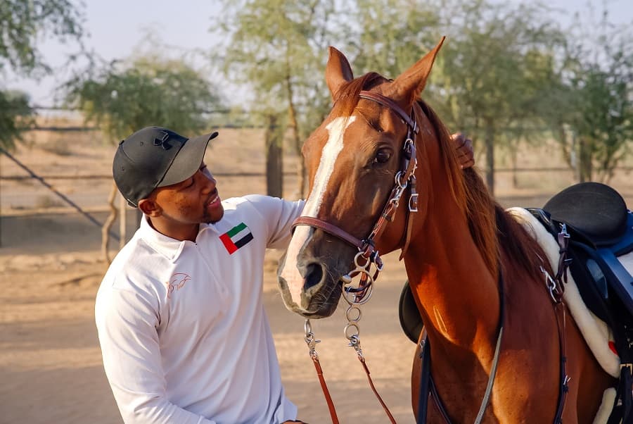 Guest enjoying a horse ride in the desert as part of the Dubai hot air balloon experience