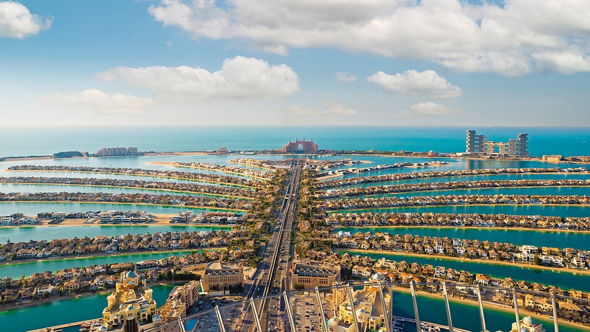 Palm Island in Dubai, UAE, showcasing its iconic palm tree shape and luxurious waterfront properties.