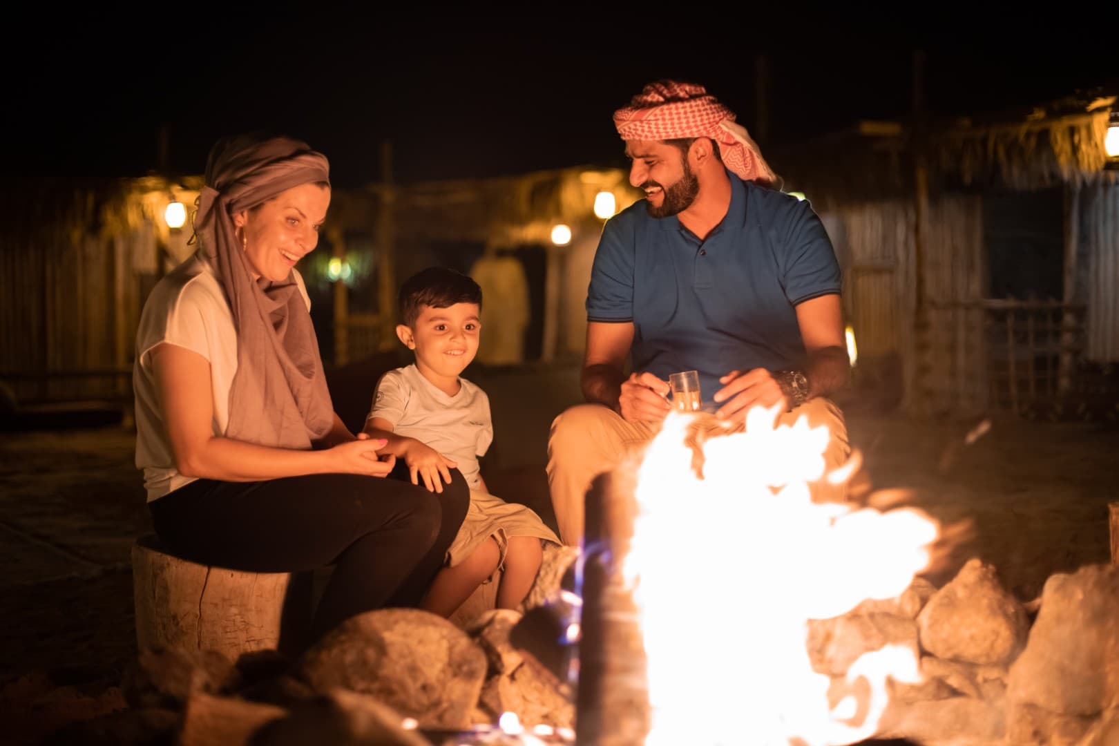 Guests gathered around a traditional bonfire at the Bedouin camp during the Heritage Desert Safari in Dubai.