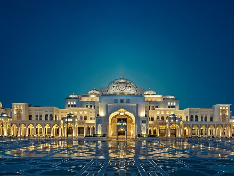 Qasr Al Watan Abu Dhabi, showcasing stunning white marble architecture and intricate domes under a clear blue sky.