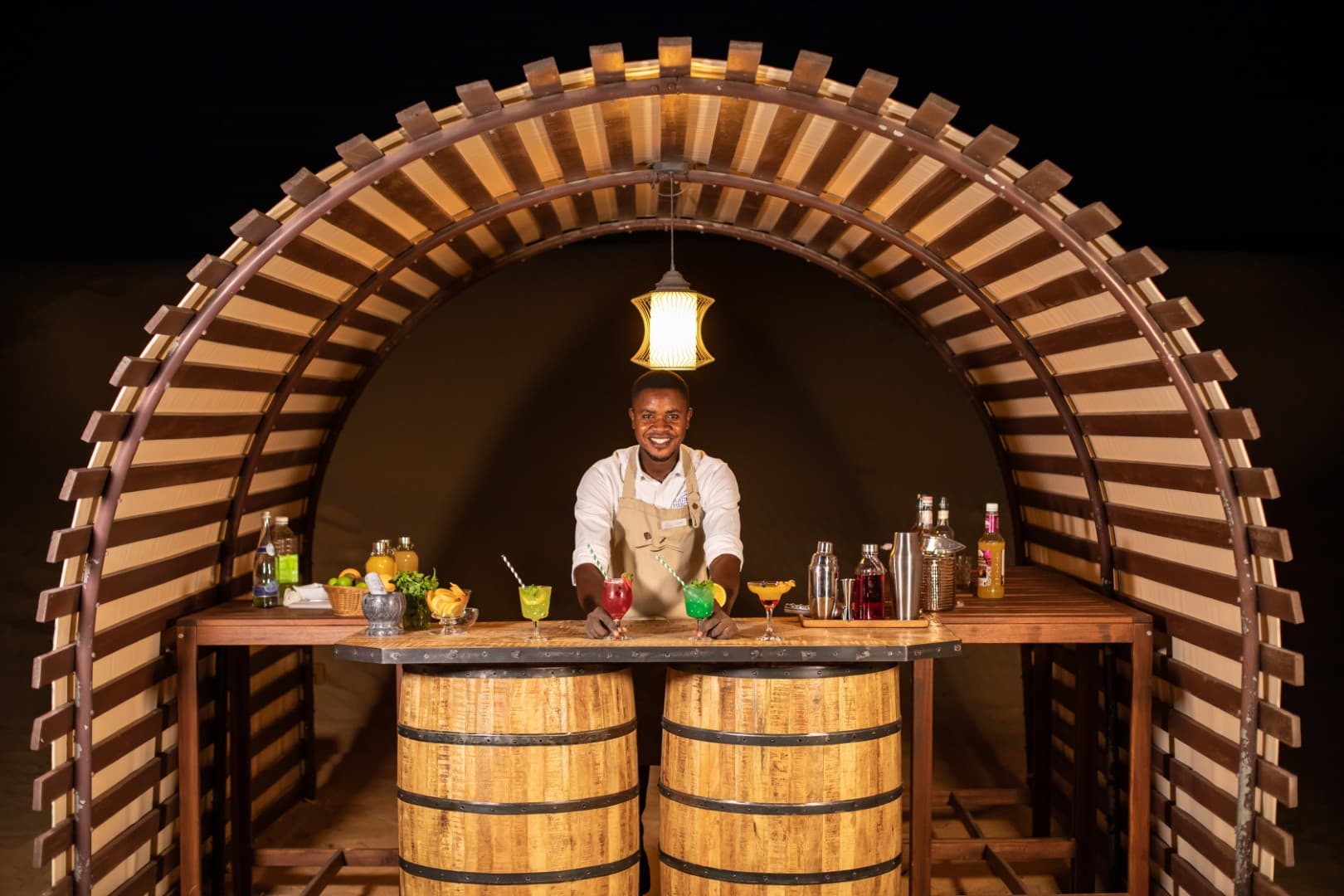 Professional chef preparing gourmet cuisine at the Platinum Desert Safari luxury camp in Dubai.