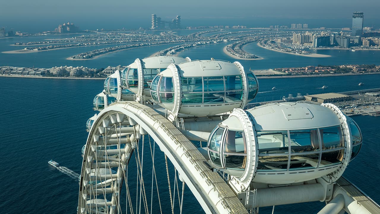 Glass observation capsules of Ain Dubai with aerial views of Palm Jumeirah and the Arabian Gulf.