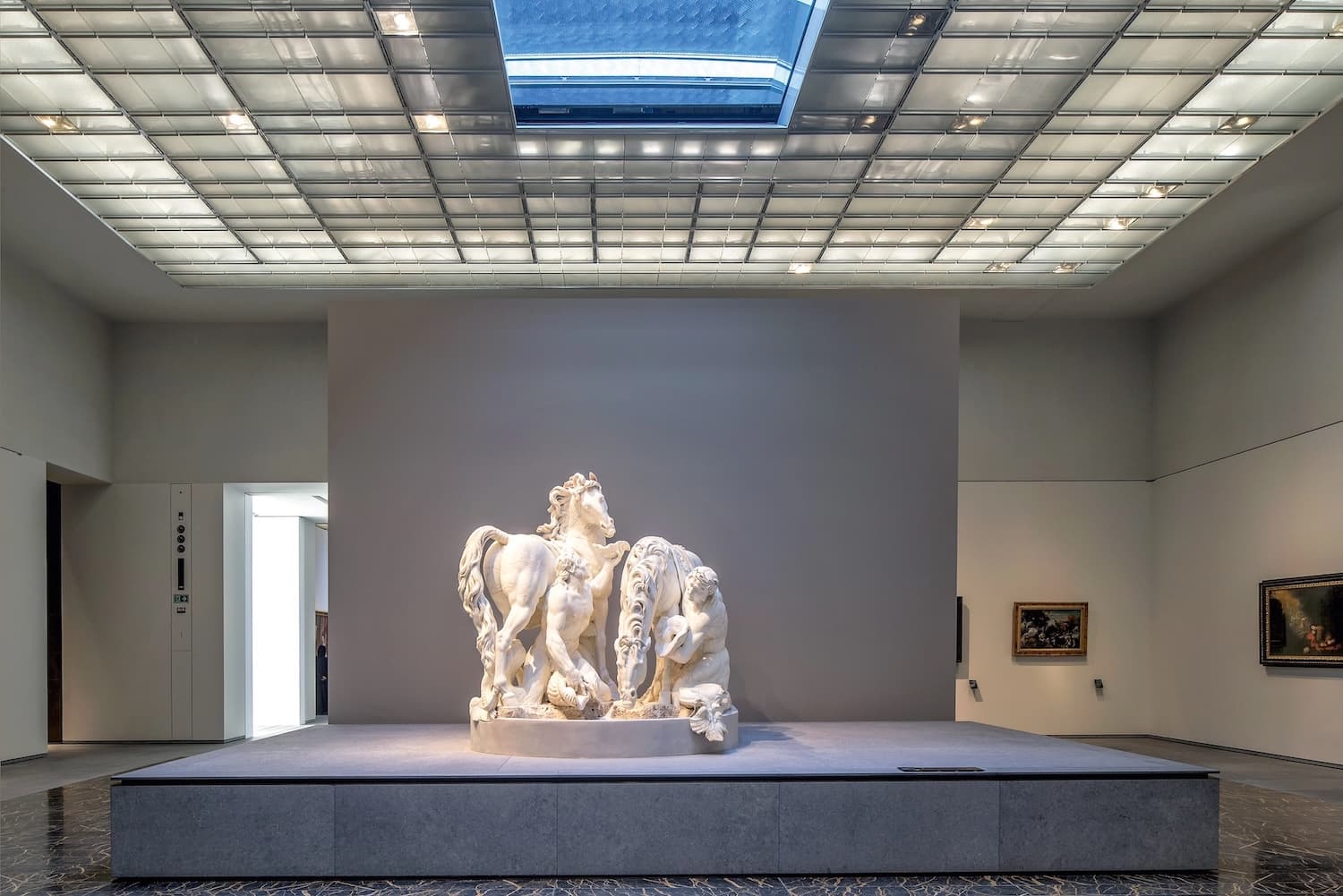 Visitors enjoying a unique cultural experience at Louvre Abu Dhabi under the iconic dome.