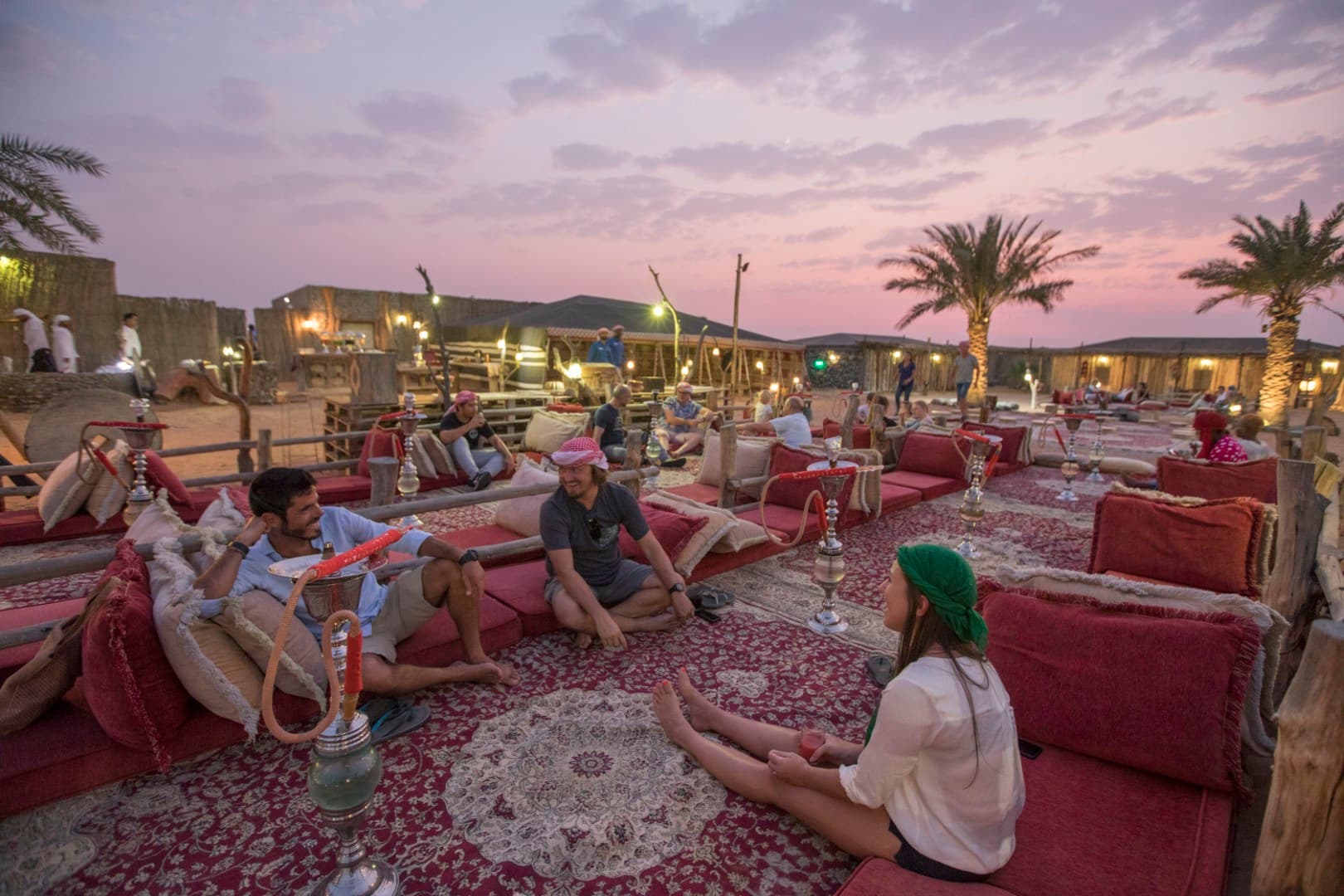 Guests relaxing in a traditional Bedouin majlis at the Heritage Desert Safari camp in Dubai.