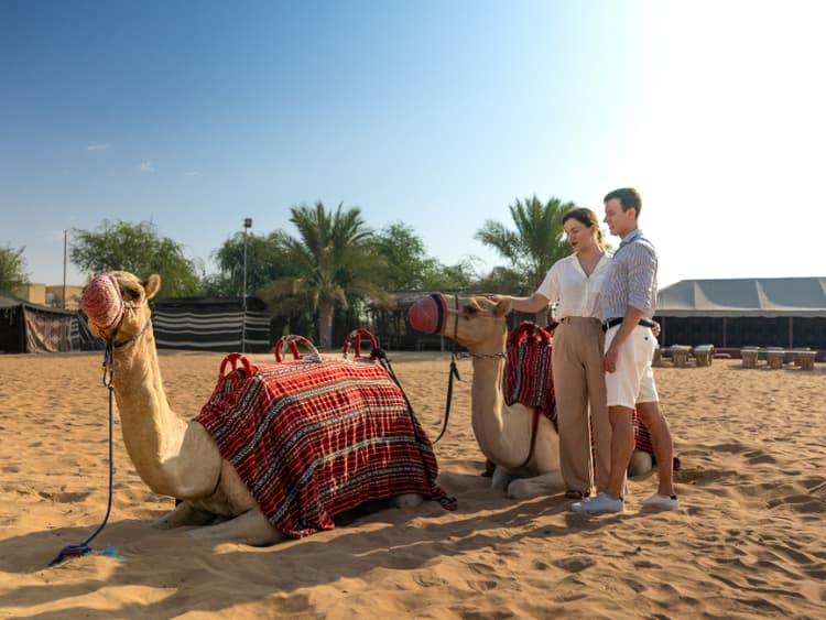 Guest enjoying a camel ride in the desert during the Dubai hot air balloon experience