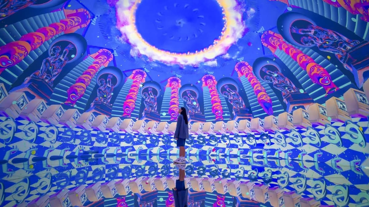 A person stands in a vibrant circular room at House of Hype Dubai, showcasing colorful walls and artistic decor.