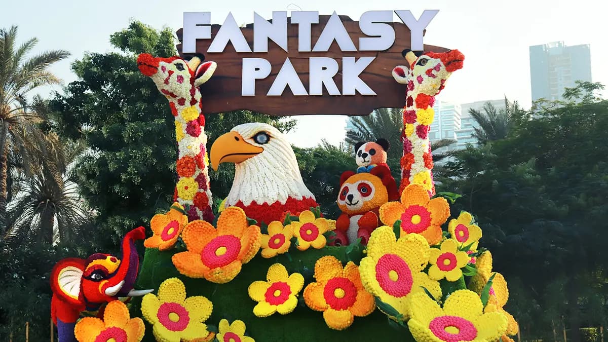 Main entrance of Dubai Garden Glow decorated with bright colorful lights and glowing art installations.