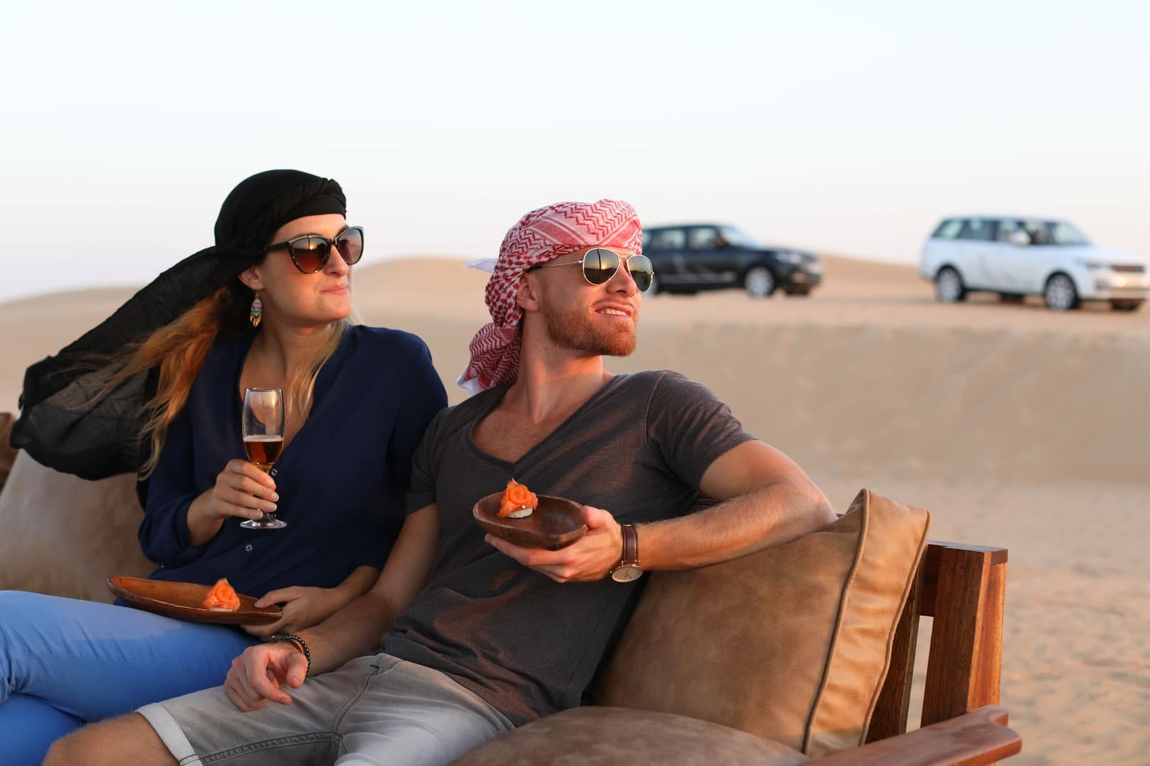 Beautiful desert sunset scene at Platinum Desert Safari in Dubai with glowing sand dunes