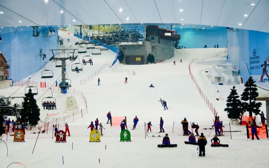 Indoor snow slope at Ski Dubai with skiers and snowboarders enjoying the winter experience