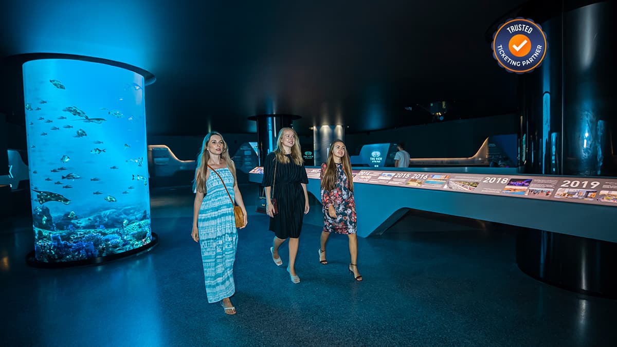 Three girls enjoying the view inside The View at The Palm while looking out over Palm Jumeirah