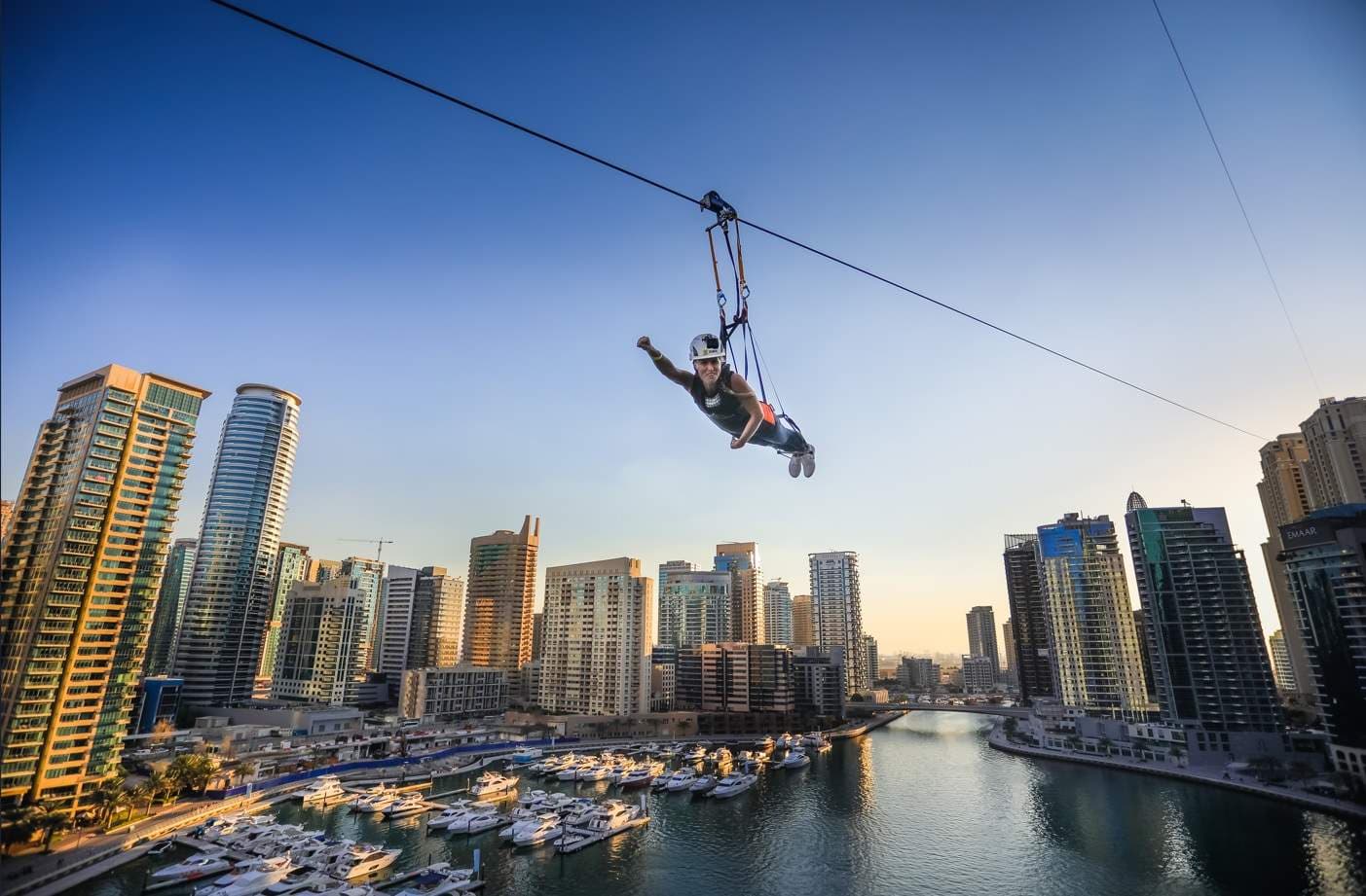 Adventurous XLine Dubai Marina zipline ride soaring above the skyscrapers and waterfront.