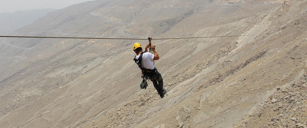 Guests ziplining between platforms during Jebel Jais Sky Tour experience