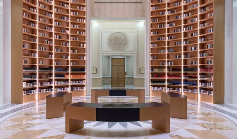Grand library inside Qasr Al Watan in Abu Dhabi featuring elegant architecture and rows of books.