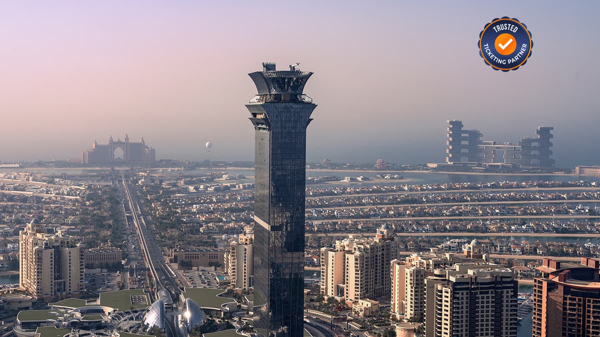 Wide panoramic view of Palm Jumeirah from The View observation deck showing the island and coastline